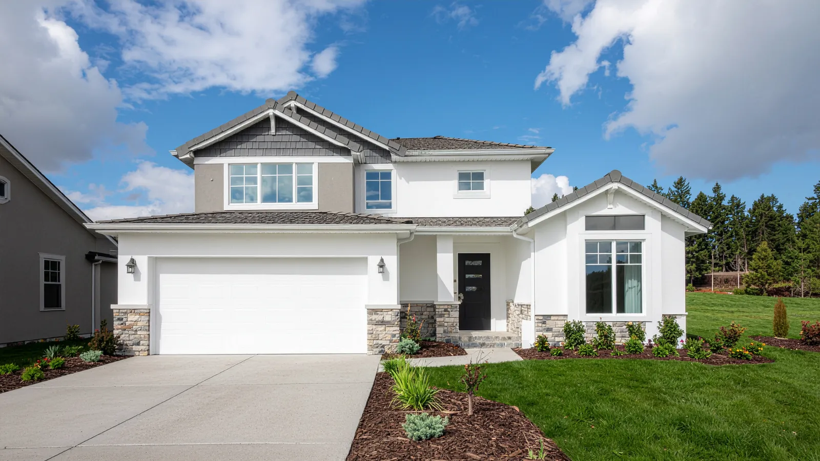 Gray shingle roof and stone accent columns on a two-story home