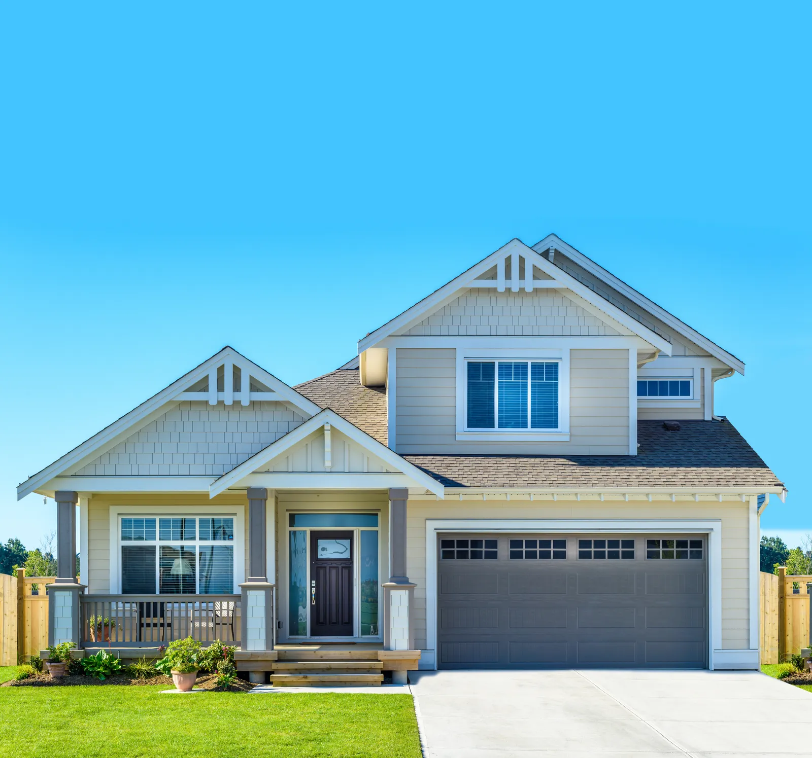 Gray shingle roof and double garage on a craftsman style home